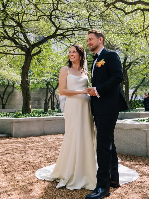 Couple in wedding attire outdoors